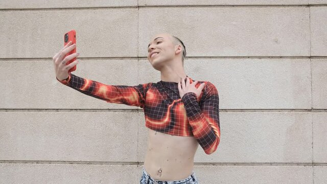 young non binary model using smartphone for videconference