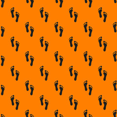 a trace of a man on an orange background. black trail. seamless pattern of images of a human footprint on an orange background. a view from above of the footprint. 3d rendering. 3d image.