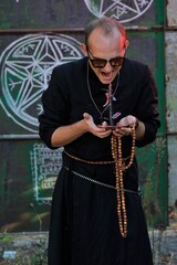 A man dressed as a priest. Halloween image. Вlack magic.
