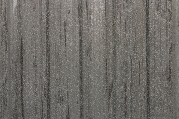 Gray corrugated metal or zinc textured surface or galvanized steel against a vertical line or texture background. Background.