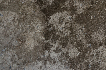 Black cracked concrete texture interspersed with small blue stones. Background.