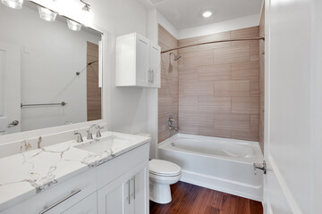 Bathroom with bathtub and shower in new luxury home with all glass shower. 