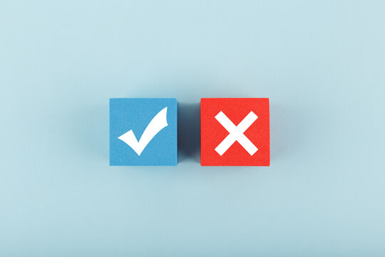 True and false symbol on blue and red cubes against bright pastel blue background. Concept of accept and reject, true or false, right or wrong