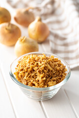 Pieces of fried onions in bowl.