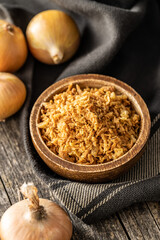 Pieces of fried onions in bowl.
