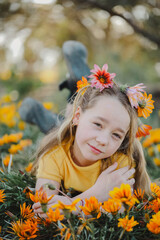 Portrait of pretty girl with vibrant orange and yellow wildflowers