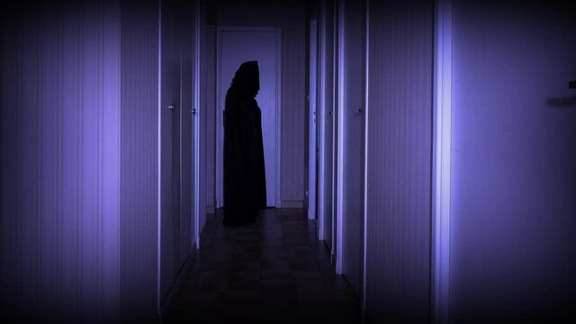 Blurred dark ghost figure emerges from the corridor wall and dissolves into rapid movement.