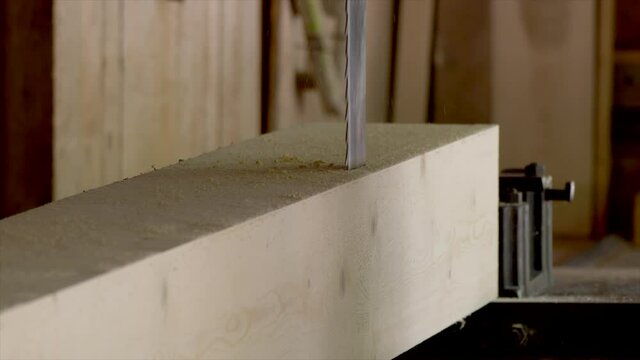 Close up of handsaw cutting wood inside workshop - slow motion - prores 4k shot