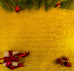 christmas and new year flat lay with copy space and with a new year toy on a gold background
