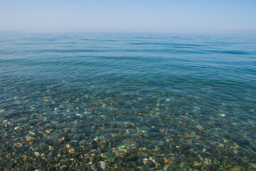 Stones in clear water of sea, water background