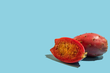 Prickly pear fruit on blue background with copy space.