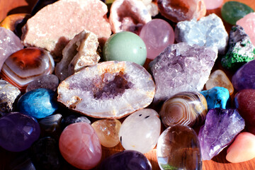Beautiful gemstones,  geode amethyst and druses of natural purple mineral amethyst on a wooden...