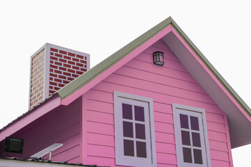 The pink triangular roof and red chimney have small solar panels attached to it.