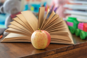 Naklejka premium Fresh apple on book background. Back to school concept.