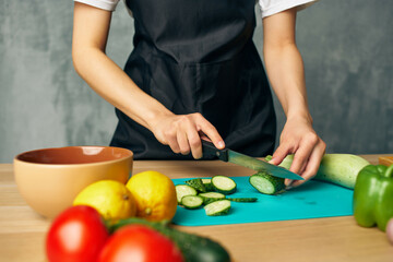 Woman in black apron lunch at home vegetarian food isolated background