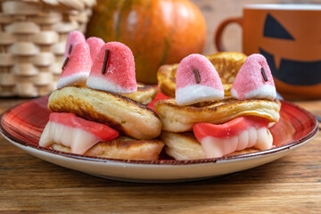Fun Halloween food ideas for kids. Halloween monster pancakes on the background of Halloween...