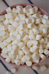 White Mini Marshmallows in a Pink Bowl, top view. Flat lay, overhead, from above.