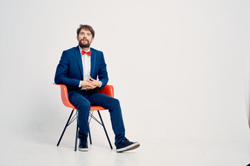 business man sitting on red chair self-confidence manager office