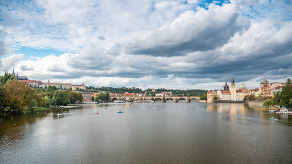 Fototapeta na wymiar Prague, Czech Republic. A view over the Vlatava River with the Charles Bridge leading towards the landmarks of Prague Castle and St. Vitus Cathedral.