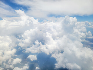 Naklejka na ściany i meble Fluffy white clouds against the blue sky