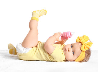 Cute baby girl with bottle of water on white background