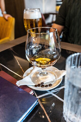Whiskey served with coffee beans on cafe bar table