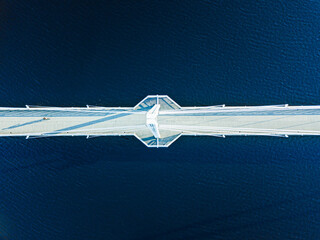 Aerial view of Ylisto footbridge over blue lake in Finland, Jyvaskyla.