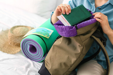 Female tourist packing things at home, closeup