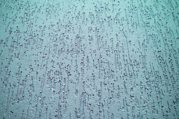 The wall is decorated with decorative plaster with vertical green lines