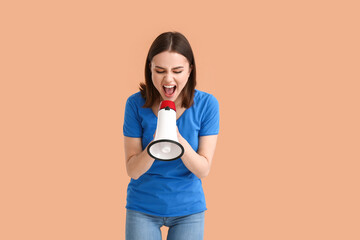 Protesting young woman with megaphone on color background