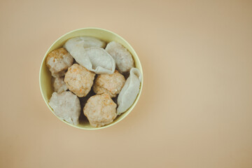 Steam of fish balls, shrimp balls and pork balls in yellow bowl