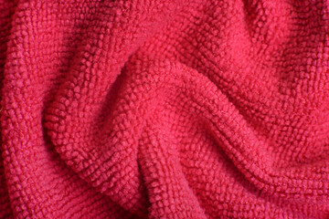 Naklejka na ściany i meble Close up of pink knitted textured background. Trendy color of the year 2022.
