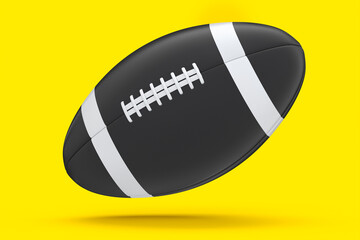 Black american football ball isolated on yellow background