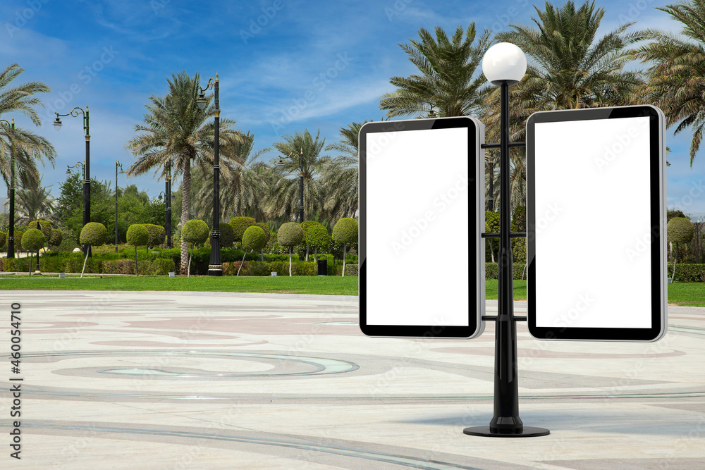 Poster street lamp with blank banners as template for your design in empty city street with palm trees. 3d 