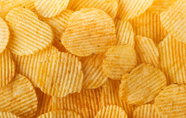 Screen filling ribbed potato chips or crisps background 