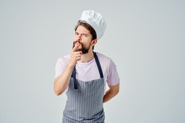 a man in a chef's uniform emotions of a professional work in the kitchen