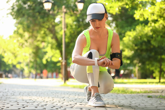 Sporty Mature Woman With Fitness Tracker Outdoors