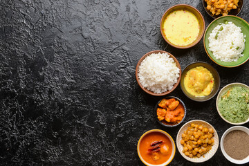 Traditional Indian food with spices on dark background