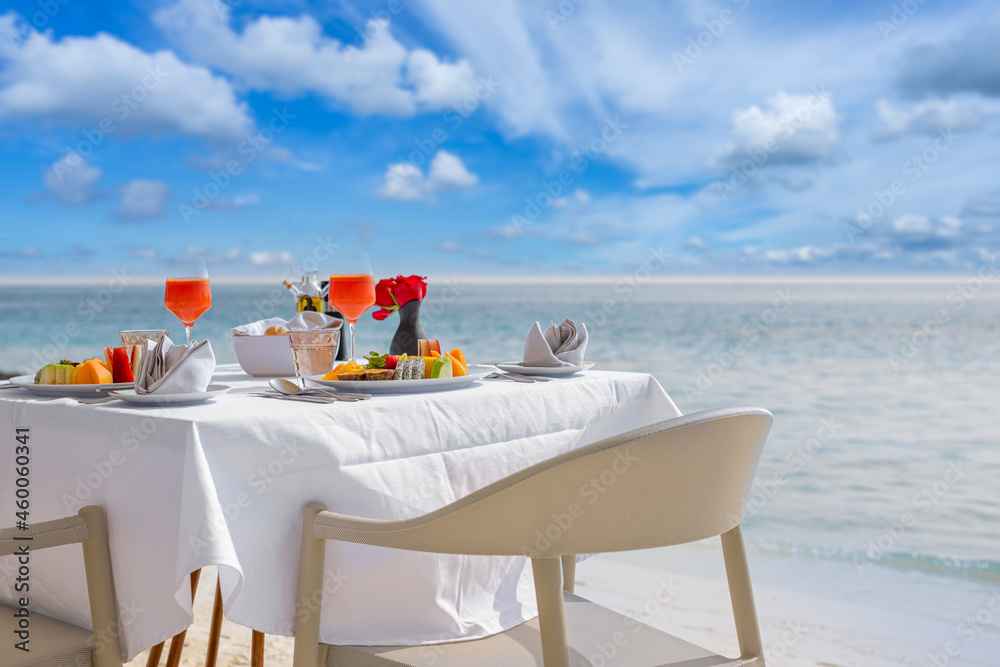 Wall mural Luxury breakfast food on white table, with beautiful tropical sea view background, morning time summer holiday and romantic vacation concept, luxury travel and lifestyle
