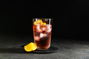 Glass of tasty Negroni cocktail on dark background