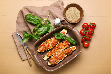 Composition with meat stuffed zucchini boats on color wooden background