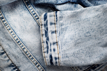 Denim texture close up. Light blue denim jacket sleeve