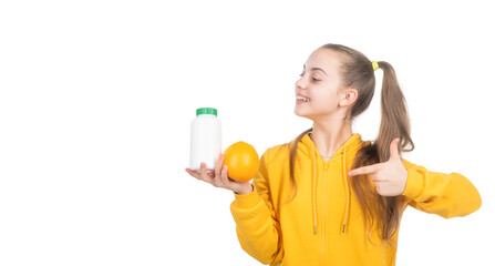 happy teen girl pointing finger on orange fruit and vitamin pill, natural supplement.