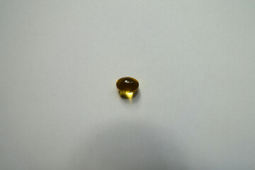 Single yellow softgel capsule of vitamin A (retinyl palmitate) from above