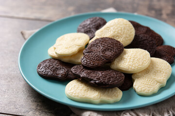 Chocolate Mexican skulls in plate on wooden table