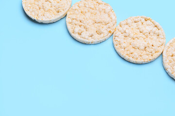 Puffed rice crackers on color background
