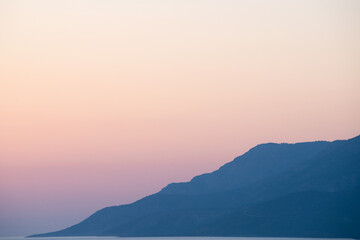 landscape of mountains and sea at sunset