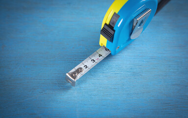 Measuring tape on the blue table.