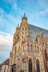 Fototapeta na wymiar Famous iconic Stephan Cathedral at sunset colors and blue sky in historical touristic downtown of Vienna, Austria.
