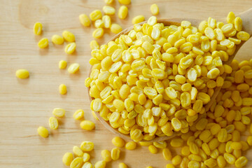 Close-up of Peeled split mung bean in spoon wooden on table,Top view. Healthy food concept.